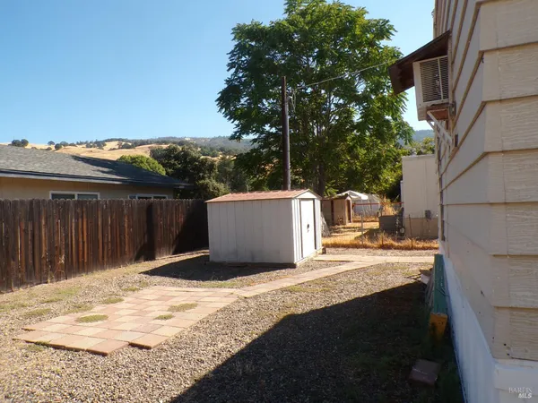 a backyard of a house with wooden fence
