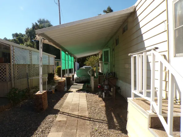 a backyard of a house with barbeque oven table and chairs