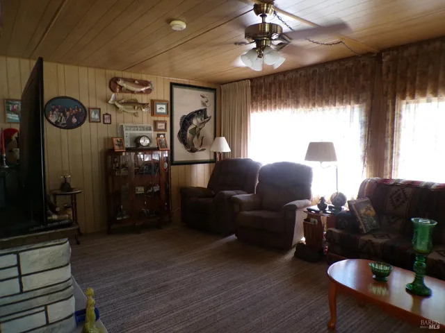 a living room with furniture a window and a chandelier