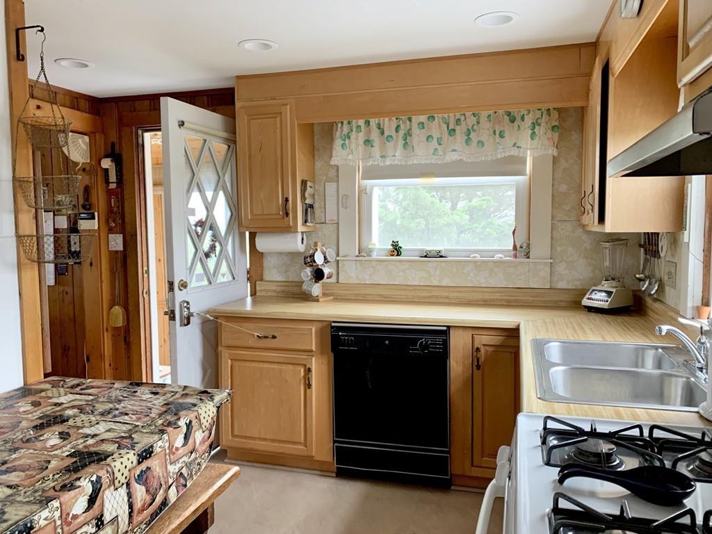 191 Phillips Road Bourne, MA 02562 - Photo 14 of 41 a kitchen with a stove a sink and a refrigerator