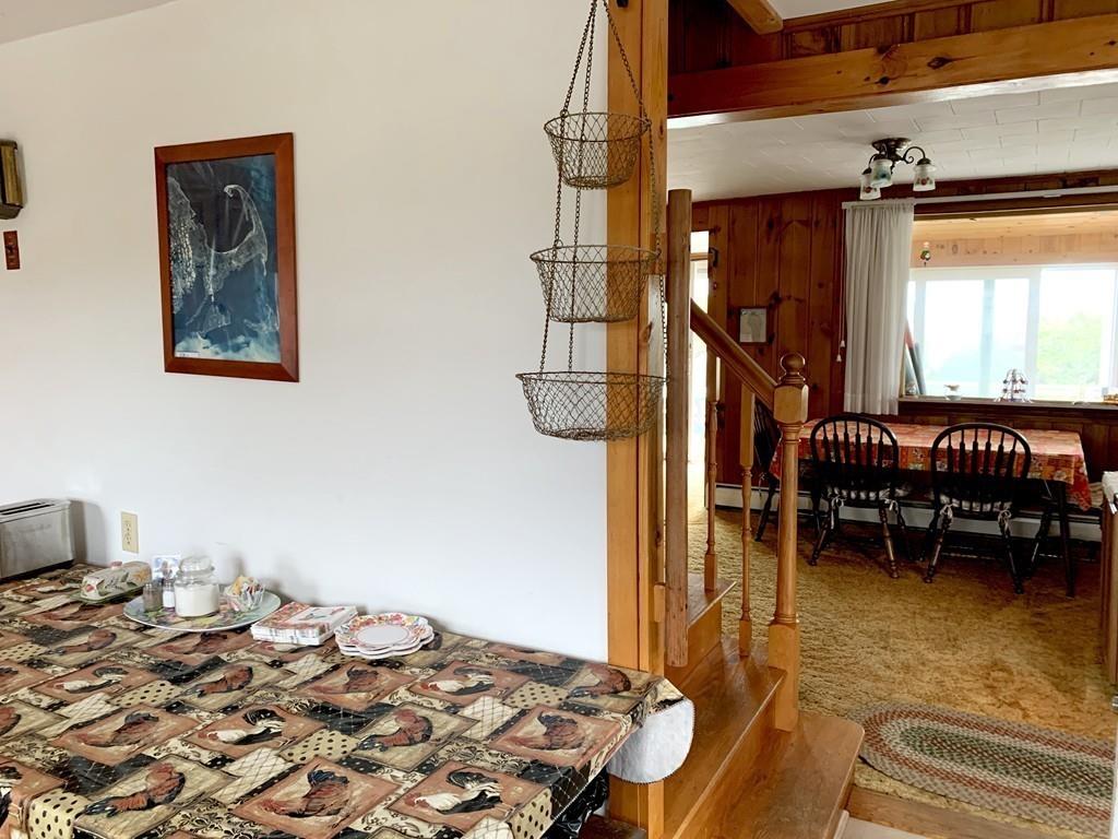 191 Phillips Road Bourne, MA 02562 - Photo 16 of 41 a bedroom with a bed and a chandelier