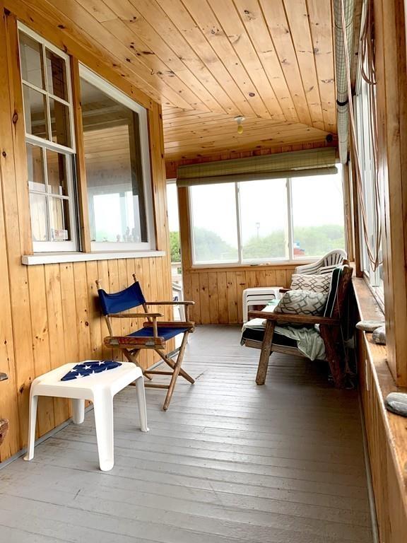191 Phillips Road Bourne, MA 02562 - Photo 18 of 41 a building outdoor space with patio furniture and wooden floor