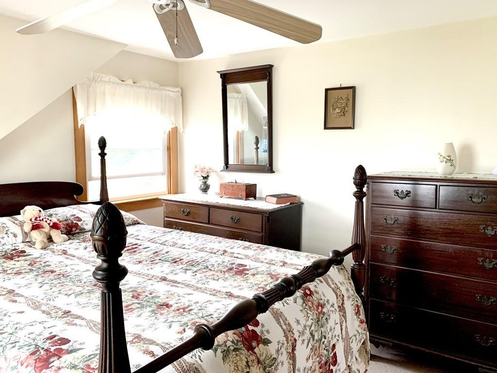 191 Phillips Road Bourne, MA 02562 - Photo 26 of 41 a bedroom with a bed and dresser with mirror