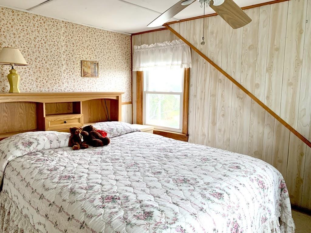 191 Phillips Road Bourne, MA 02562 - Photo 30 of 41 a bed room with a bed and a chair