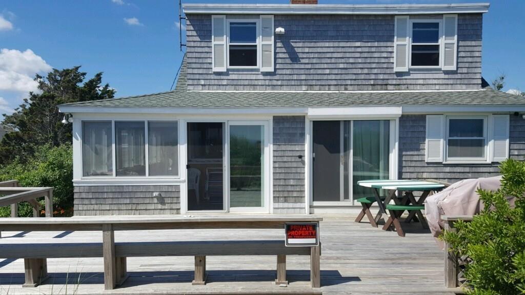 191 Phillips Road Bourne, MA 02562 - Photo 3 of 41 a view of a house with a chairs and table in a patio