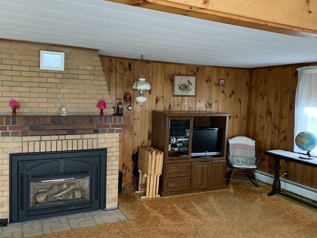 191 Phillips Road Bourne, MA 02562 - Photo 8 of 41 a living room with furniture and a fireplace