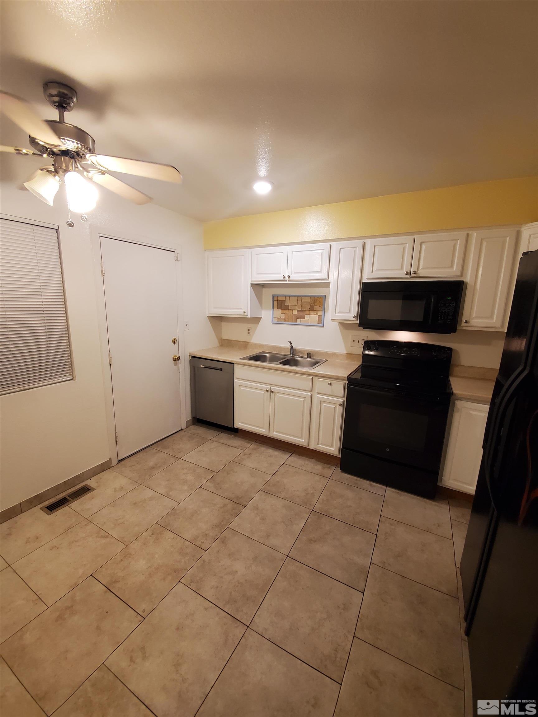 1422 East 9th Street, Unit 1 Reno, NV 89512 - Photo 4 of 22 a kitchen with a stove a sink and a refrigerator
