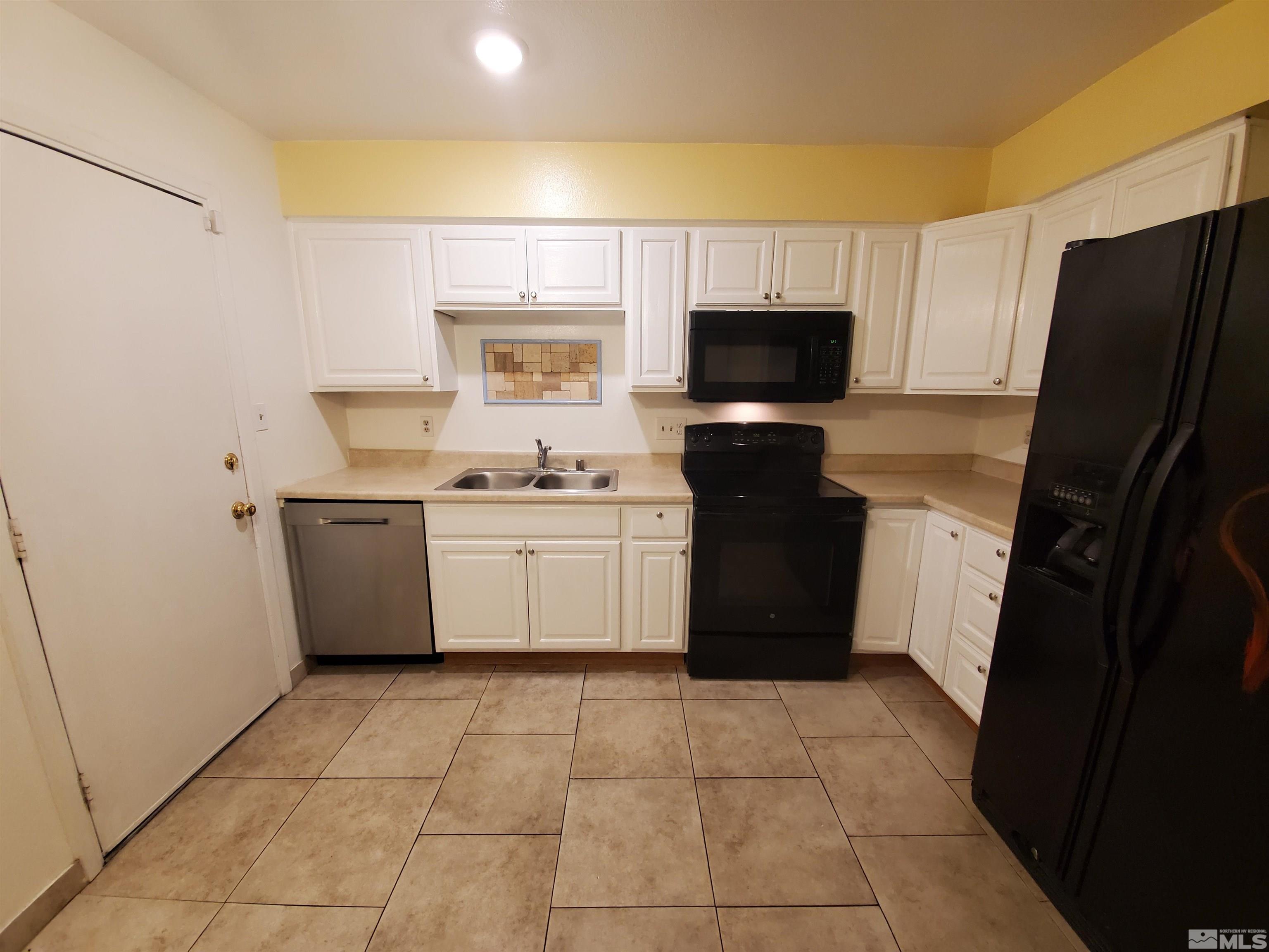1422 East 9th Street, Unit 1 Reno, NV 89512 - Photo 5 of 22 a kitchen with a sink a stove top oven and refrigerator