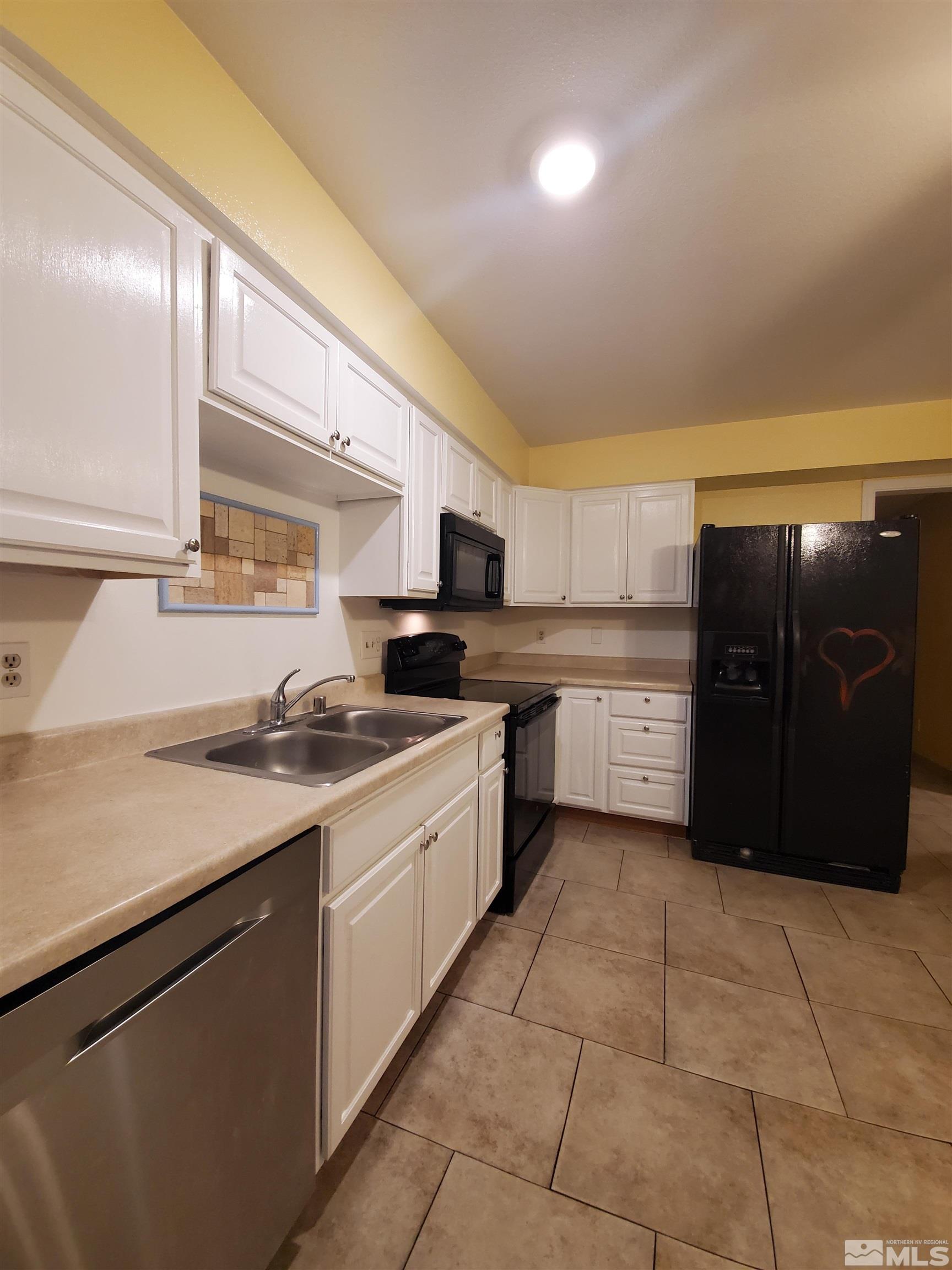 1422 East 9th Street, Unit 1 Reno, NV 89512 - Photo 6 of 22 a kitchen with a sink a stove and cabinets