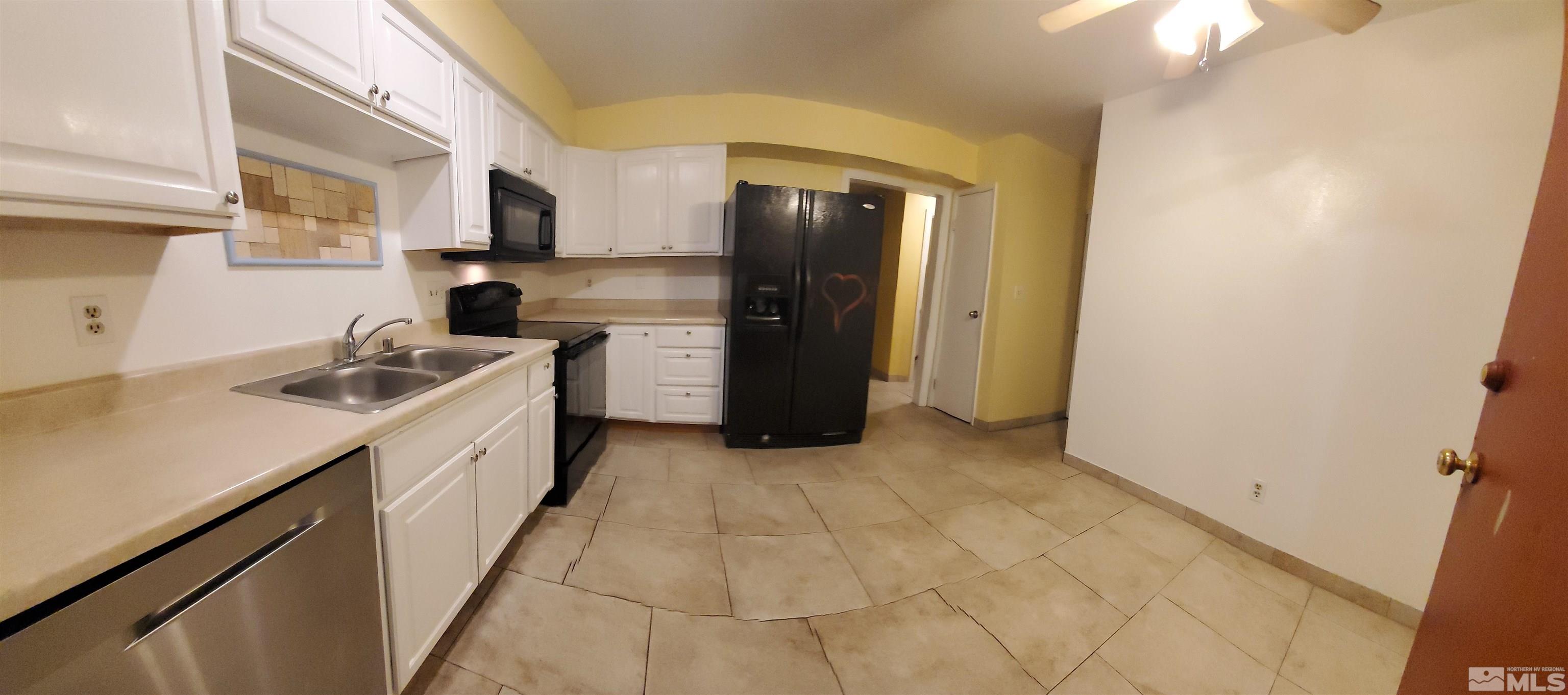 1422 East 9th Street, Unit 1 Reno, NV 89512 - Photo 7 of 22 a kitchen with a sink cabinets and a refrigerator