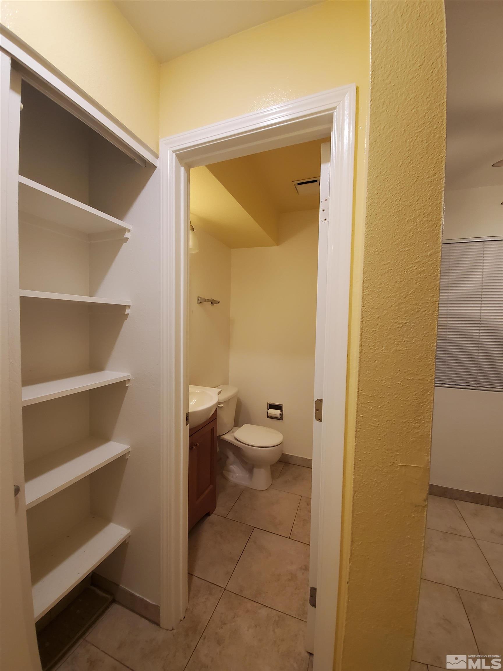 1422 East 9th Street, Unit 1 Reno, NV 89512 - Photo 9 of 22 a bathroom with a toilet and a glass door shower