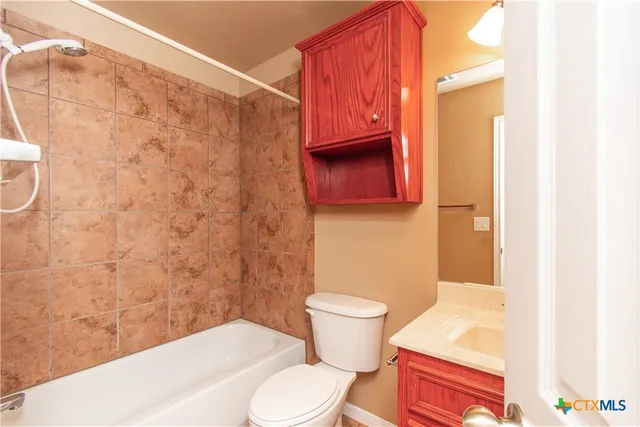 a bathroom with a toilet and a shower curtain