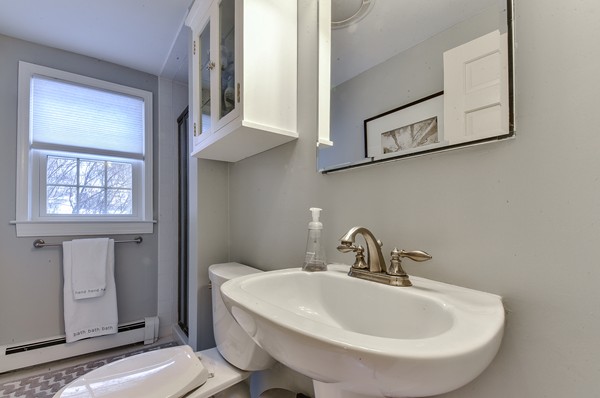 15 Charles Street Natick, MA 01760 - Photo 14 of 21 a bathroom with a sink and a mirror