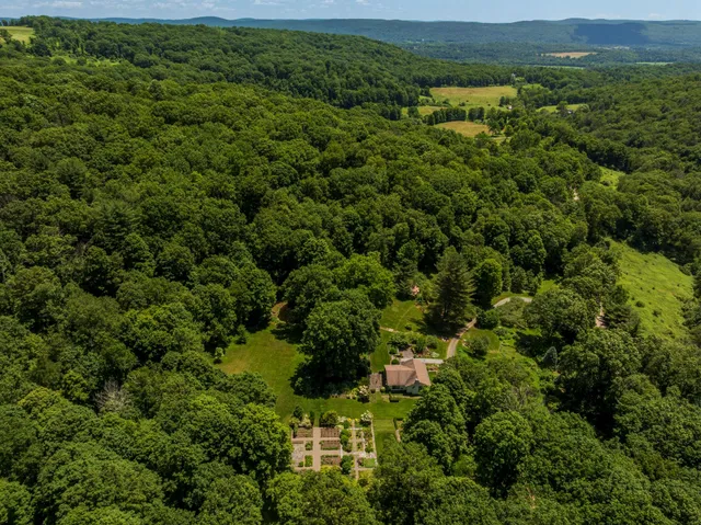 an aerial view of a houses with a yard