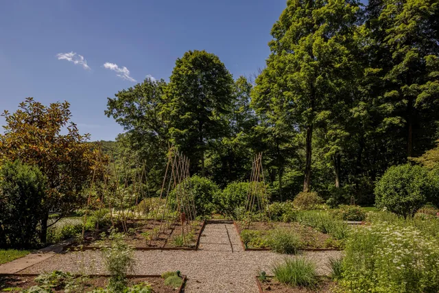 a kitchen with stainless steel appliances granite countertop a dining table chairs and a stove