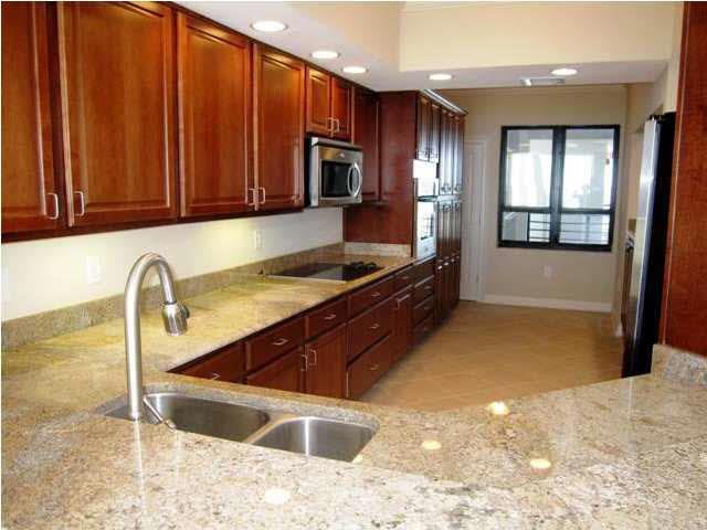 13335 Johnson Beach Road, Unit 802 Pensacola, FL 32507 - Photo 4 of 24 Rich wood paneling and stainless appliances in gourmet kitchen.