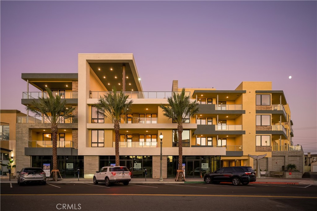 a couple of cars parked in front of a building