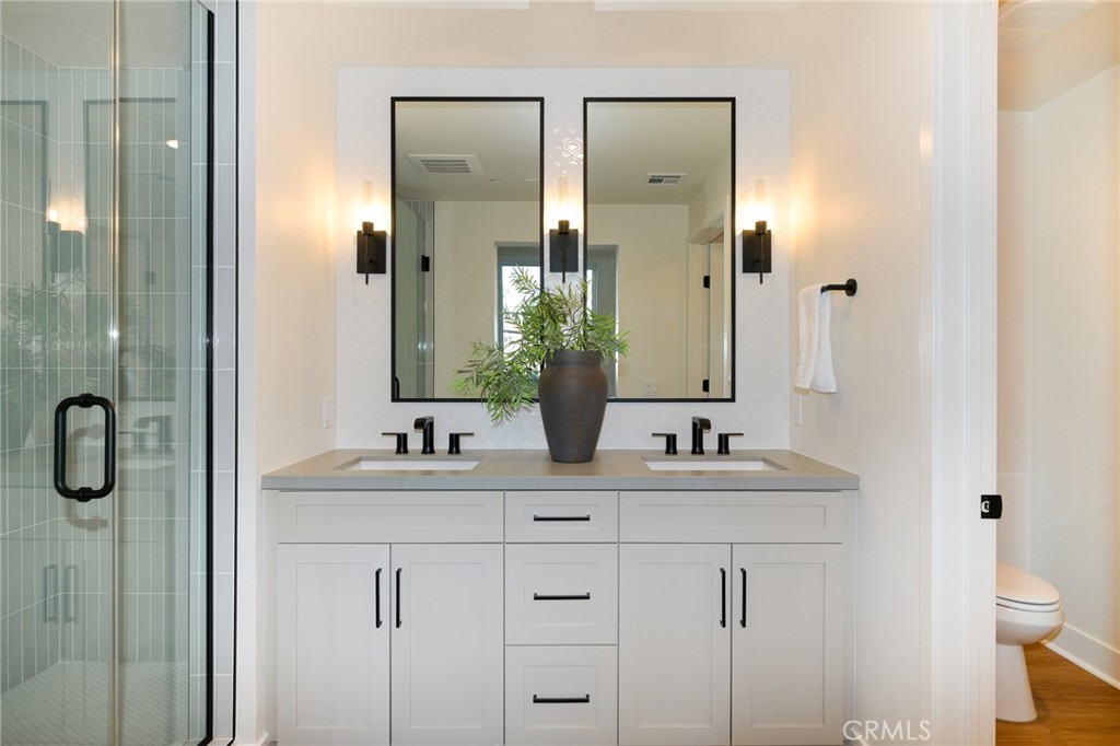 414 Main Street, Unit 400 Huntington Beach, CA 92648 - Photo 13 of 29 a bathroom with a double vanity sink mirror and shower