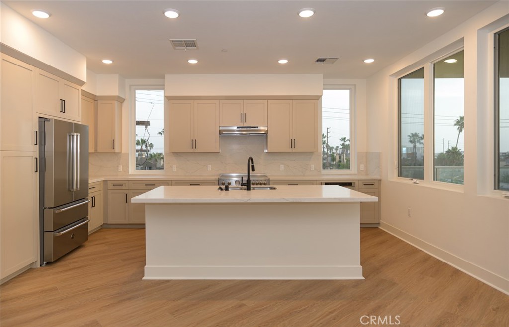 414 Main Street, Unit 400 Huntington Beach, CA 92648 - Photo 3 of 29 a kitchen with stainless steel appliances a sink stove and refrigerator