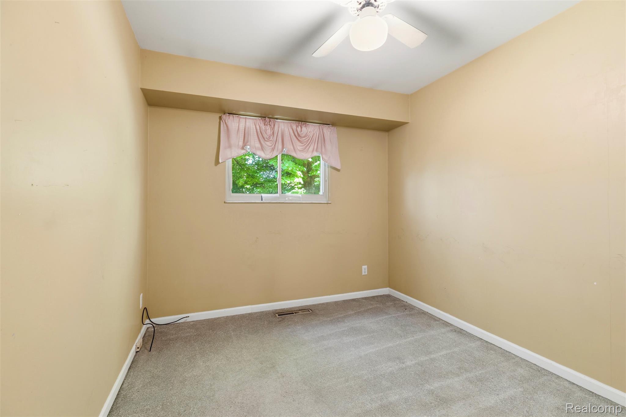 309 Windy Bluff Street Flushing, MI 48433 - Photo 12 of 32 Bedroom featuring neutral-toned walls, grey carpeting, and a ceiling fan with integrated lighting