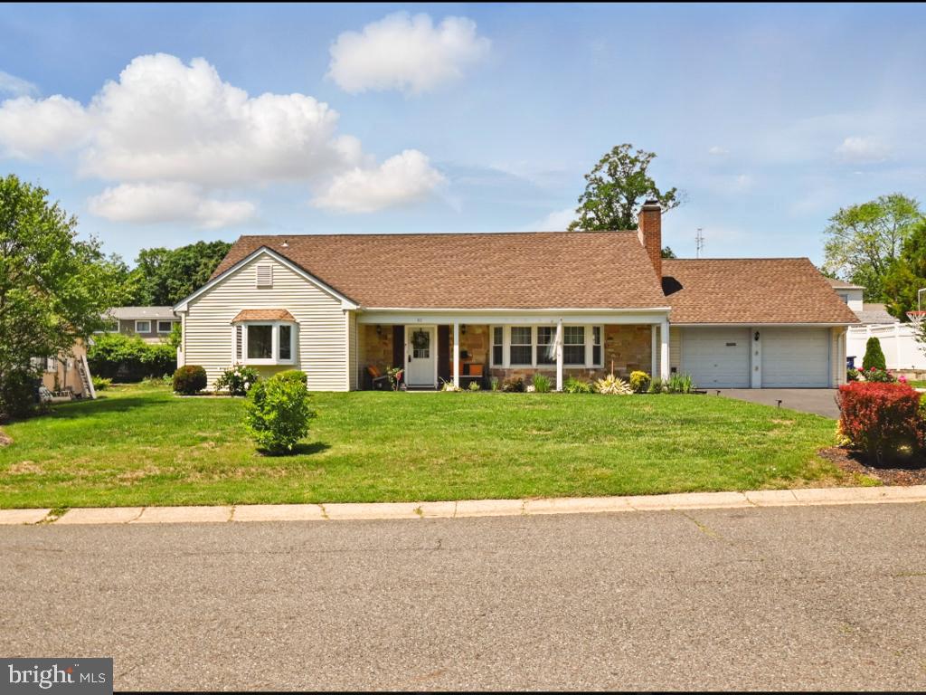 60 Windsor Lane Willingboro, NJ 08046 - Photo 16 of 58 a front view of a house with a yard and garage