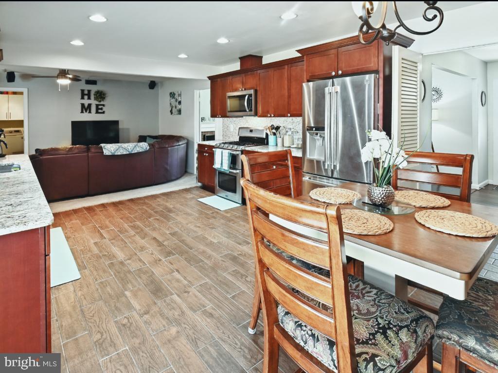 60 Windsor Lane Willingboro, NJ 08046 - Photo 23 of 58 a kitchen with stainless steel appliances kitchen island granite countertop a sink and a refrigerator