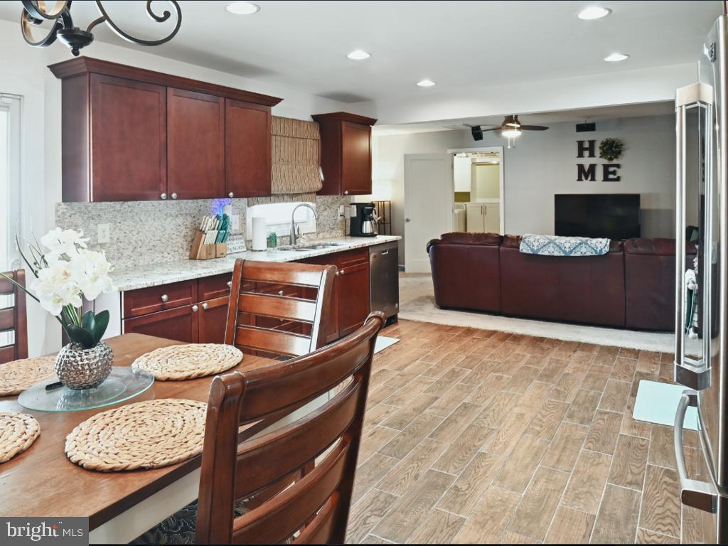 60 Windsor Lane Willingboro, NJ 08046 - Photo 25 of 58 a kitchen with stainless steel appliances kitchen island granite countertop a table chairs and a refrigerator