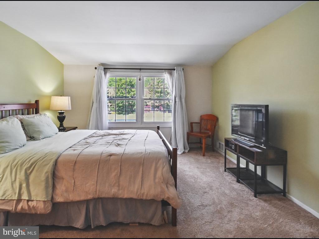 60 Windsor Lane Willingboro, NJ 08046 - Photo 40 of 58 a bedroom with a bed and a flat tv screen on dresser
