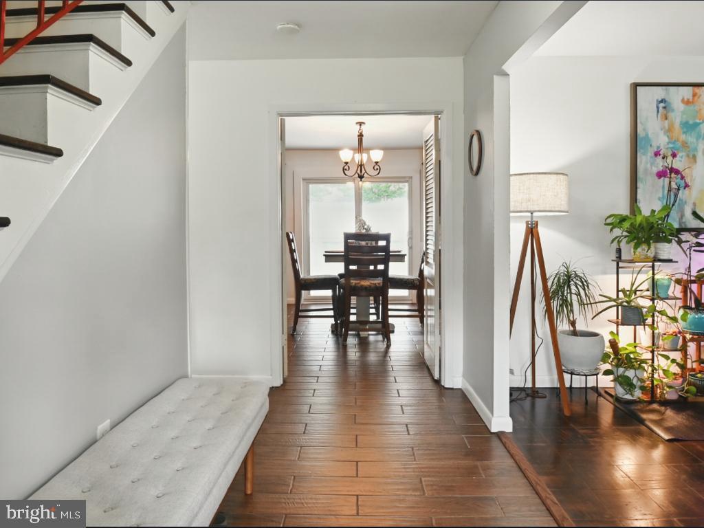 60 Windsor Lane Willingboro, NJ 08046 - Photo 45 of 58 a hallway with wooden floor table and chairs