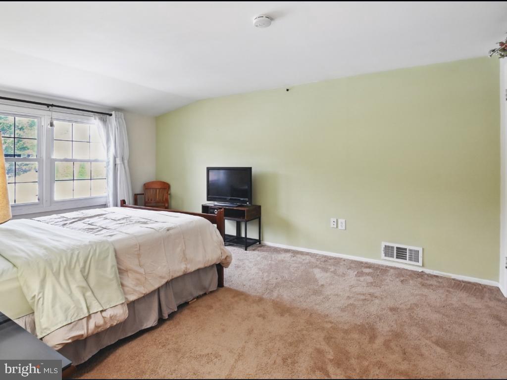 60 Windsor Lane Willingboro, NJ 08046 - Photo 52 of 58 a bedroom with a bed and a chair