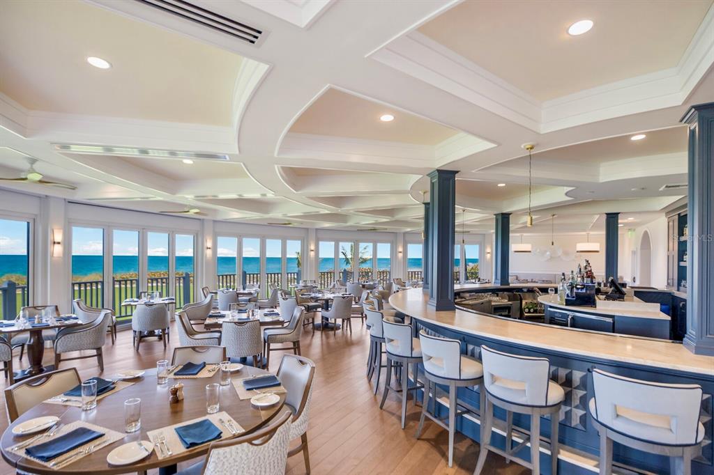 641 Boca Bay Drive Boca Grande, FL 33921 - Photo 64 of 74 a room with lots of tables a large window and chairs