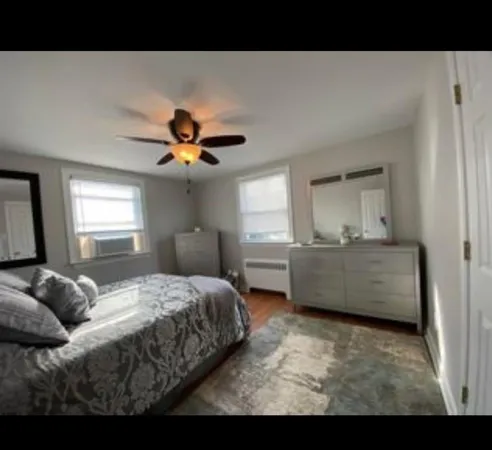 a living room with a bed furniture and a window