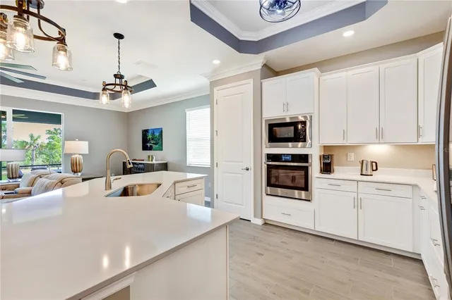 a kitchen with white cabinets and appliances
