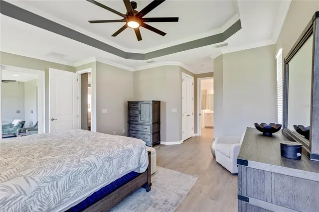 a bedroom with a bed and a chandelier