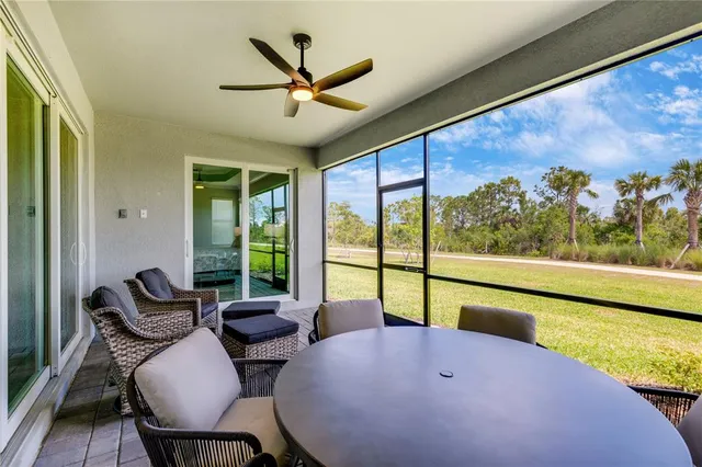 a swimming pool view with a seating space and a garden view