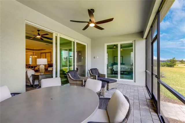 a front view of a house with glass windows and furniture