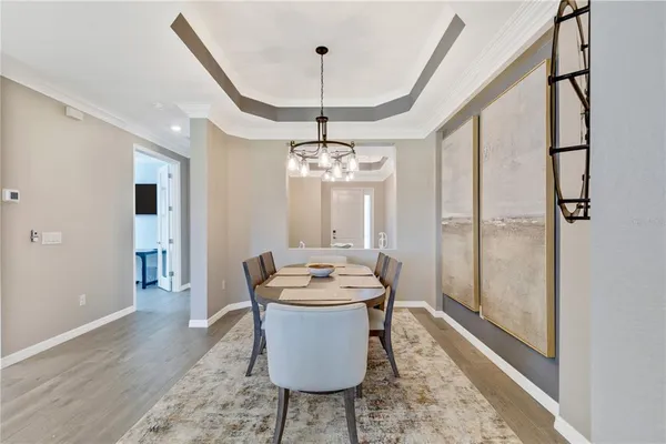 a living room with furniture a chandelier and a rug