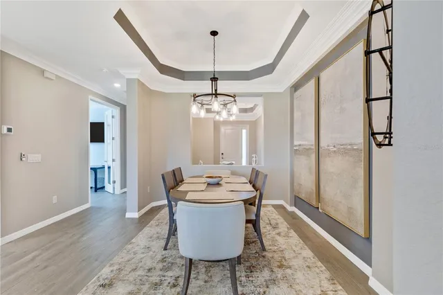 a living room with furniture a chandelier and a rug