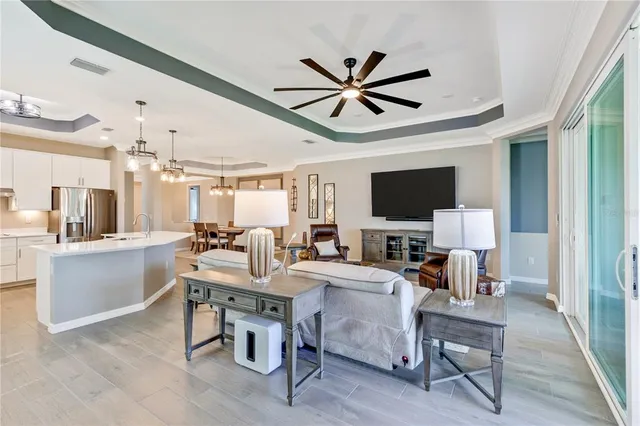 a living room with furniture a table and a large window