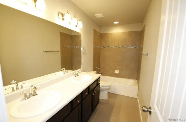 a bathroom with a double vanity sink mirror and double