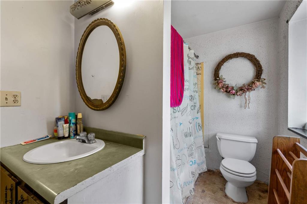 1781 Ivanhoe Drive Irwin, PA 15642 - Photo 11 of 35 a bathroom with a sink a mirror and a toilet