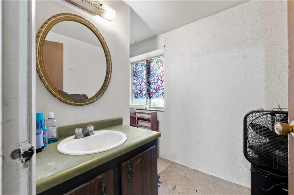 1781 Ivanhoe Drive Irwin, PA 15642 - Photo 12 of 35 a bathroom with a sink and a mirror