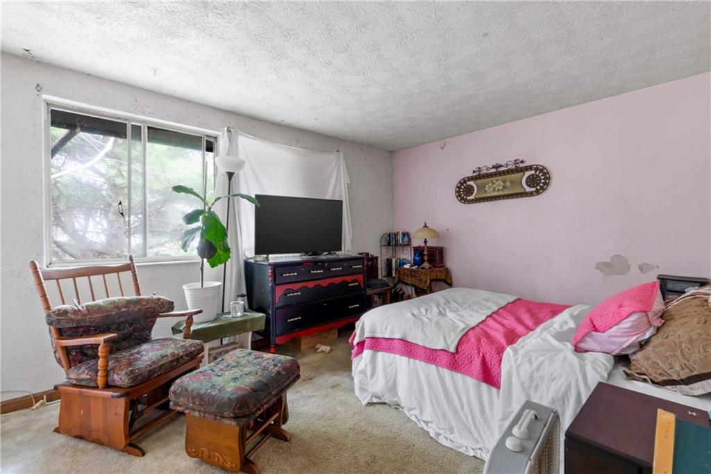 1781 Ivanhoe Drive Irwin, PA 15642 - Photo 22 of 35 a bedroom with a bed and a flat screen tv