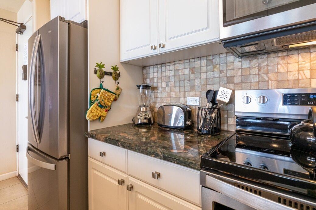 191 North Kihei Road, Unit 502 Kihei, HI 96753 - Photo 15 of 37 a kitchen with a refrigerator and a stove