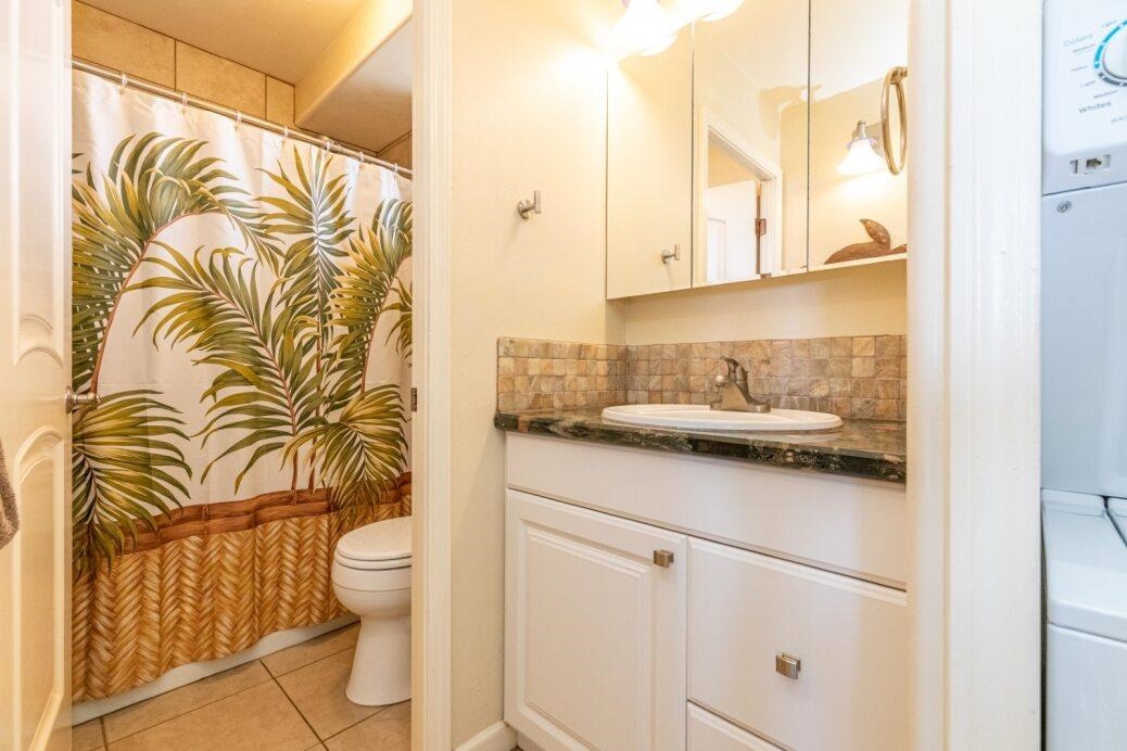 191 North Kihei Road, Unit 502 Kihei, HI 96753 - Photo 17 of 37 a bathroom with a sink a toilet and a mirror