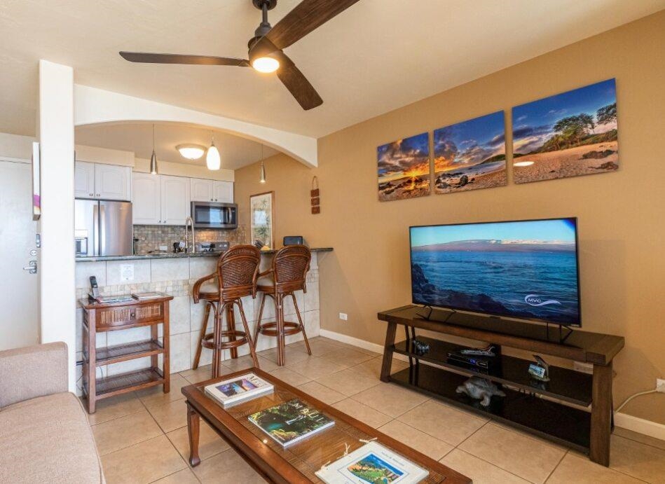 191 North Kihei Road, Unit 502 Kihei, HI 96753 - Photo 7 of 37 a living room with furniture and a flat screen tv
