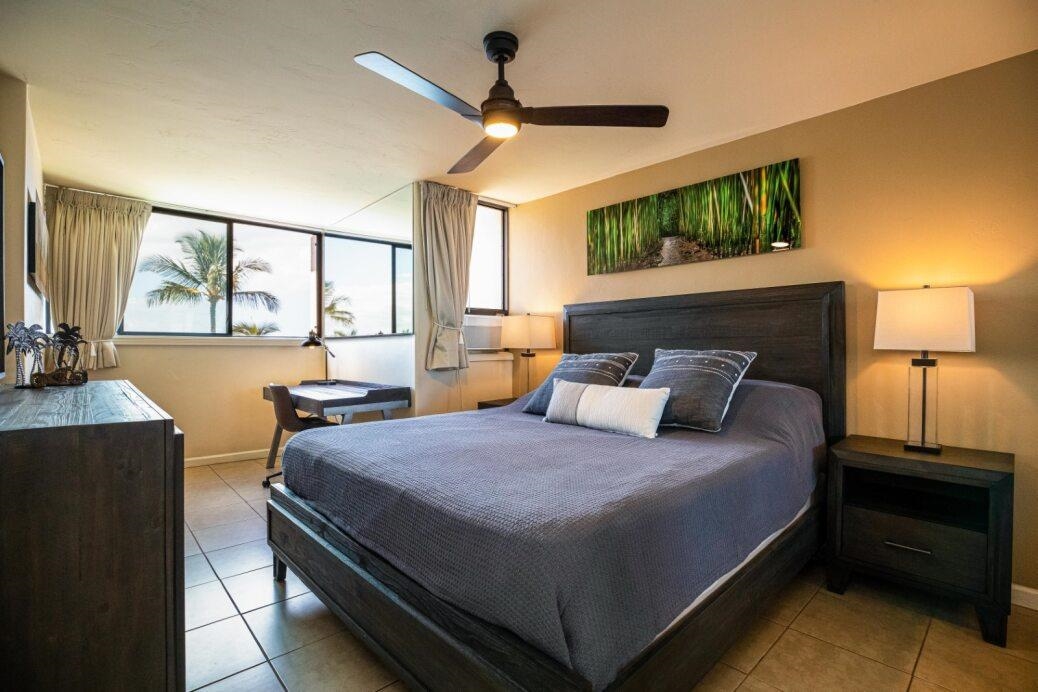 191 North Kihei Road, Unit 502 Kihei, HI 96753 - Photo 9 of 37 a bedroom with a bed a window and potted plant