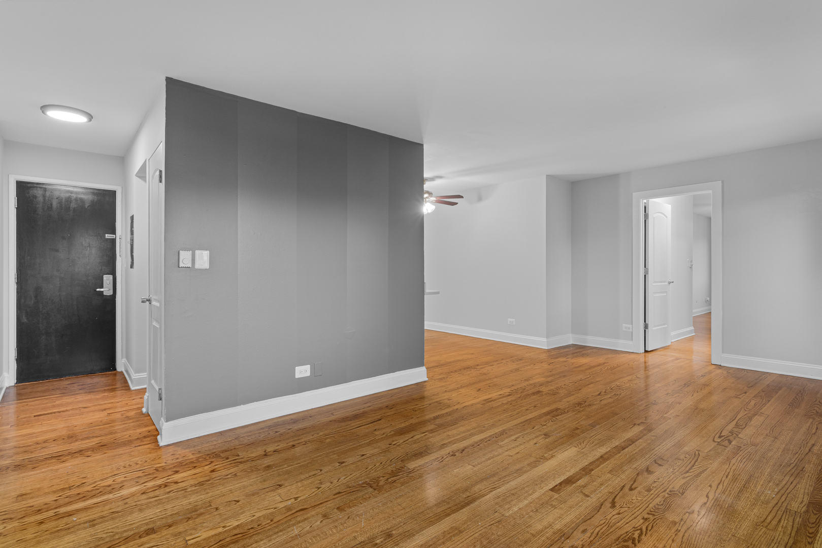 7545 North Winchester Avenue, Unit 303 Chicago, IL 60626 - Photo 7 of 13 a view of an empty room with wooden floor