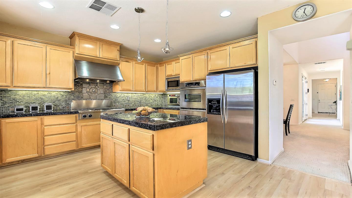100 Mintaro Court San Ramon, CA 94582 - Photo 11 of 26 a kitchen with stainless steel appliances granite countertop a stove refrigerator and cabinets