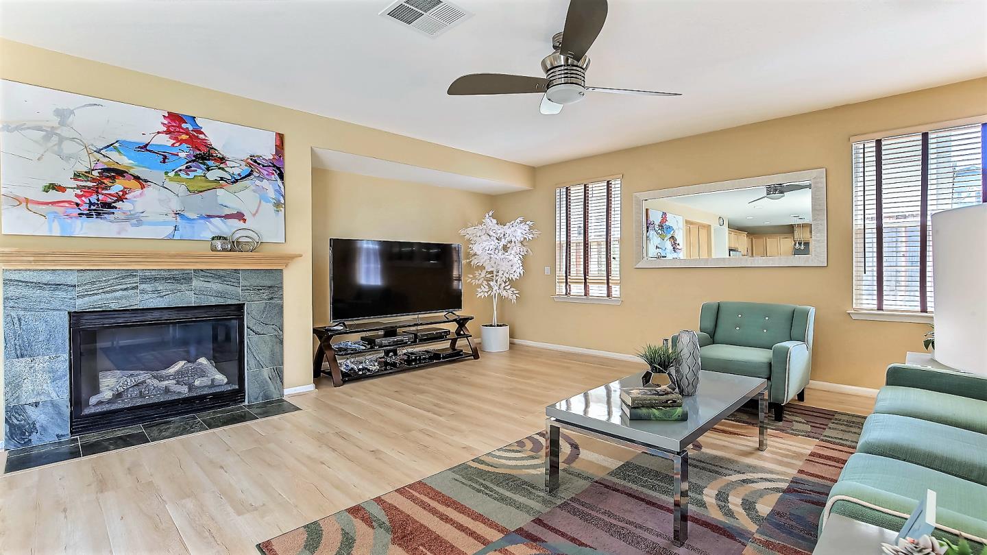 100 Mintaro Court San Ramon, CA 94582 - Photo 6 of 26 a living room with furniture a flat screen tv and a fireplace
